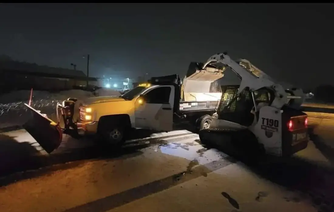 Commercial snow removal truck and skid steer working during a winter storm in Lackawanna County Pennsylvania